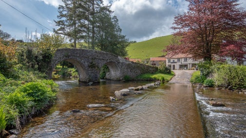 The bridge and the village of Malmsmead viewed from the river at Lorna Doone Valley
